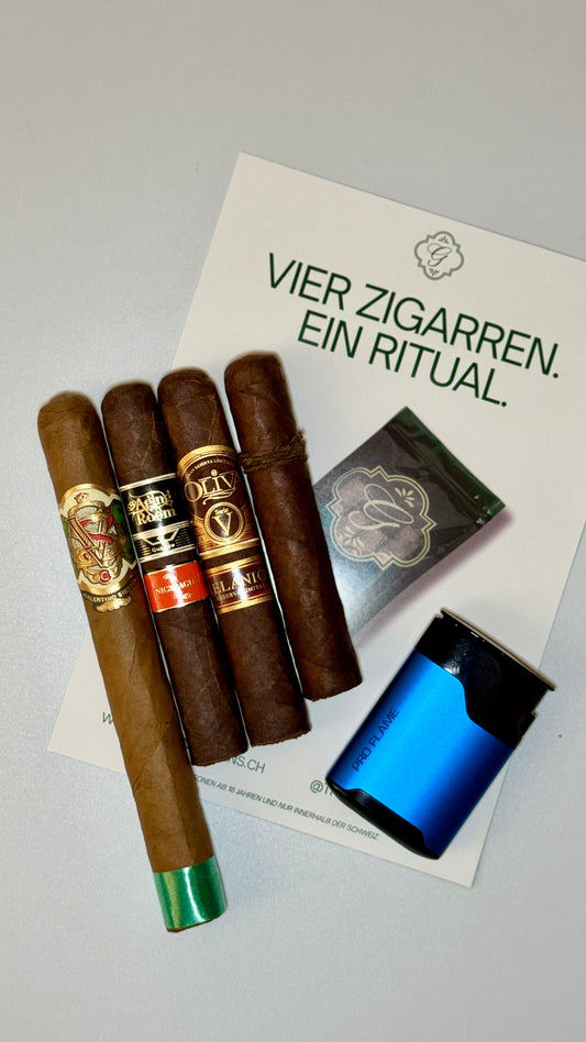 Four premium cigars — CAO Amazon Basin Rothschild, Aging Room Quattro Nicaragua Espressivo, Oliva Serie V Melanio, Valentino Siesto Connecticut 1971 Churchill — on The Gentlemen’s Cigar Pack signature packaging, Switzerland.